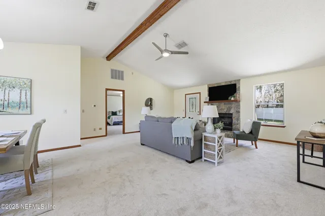 a living room with furniture and a fireplace