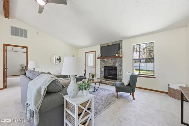 a living room with furniture and a fireplace