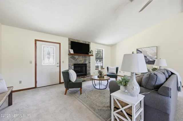 a living room with furniture and a fireplace