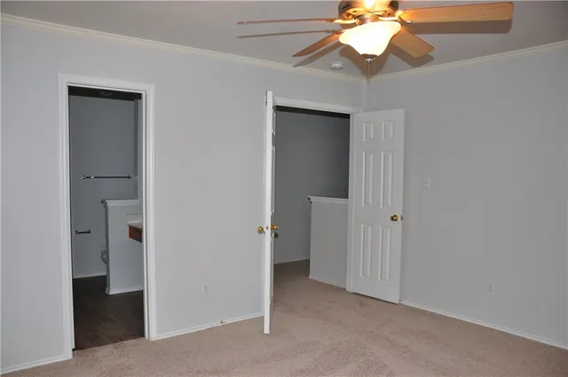 a view of a room with a chandelier fan and closet area