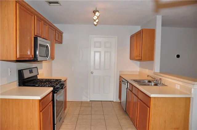 a kitchen that has a sink and a stove