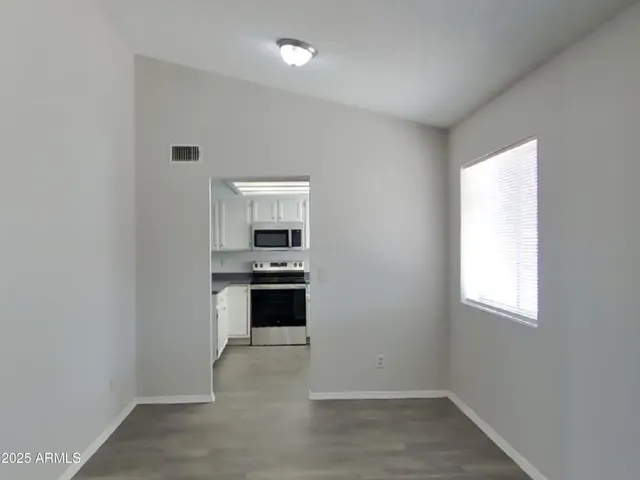 a kitchen with granite countertop a stove and a refrigerator