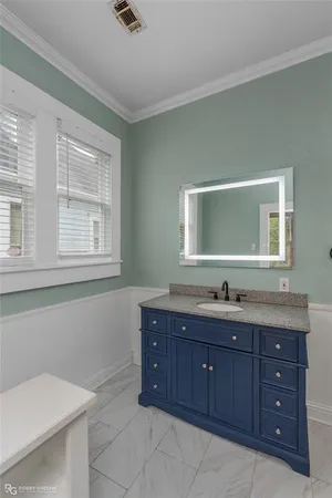 a bathroom with a granite countertop sink and mirror