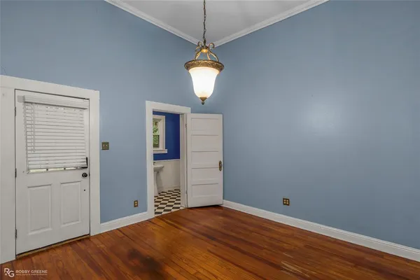 a view of a room with wooden floor and windows