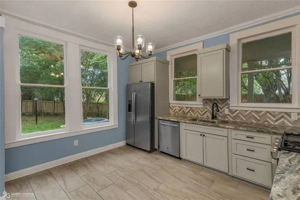 a bathroom with a double vanity sink a large mirror and a window