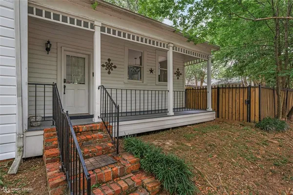 a view of backyard with deck and outdoor seating