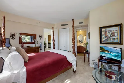 a bedroom with a bed a couch and dresser