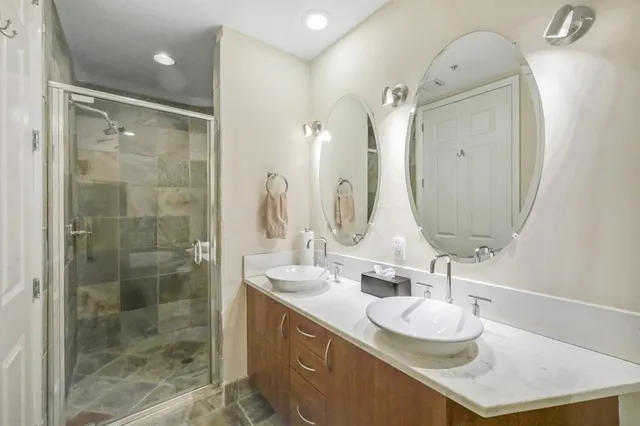 a bathroom with double vanity sinks and a mirror