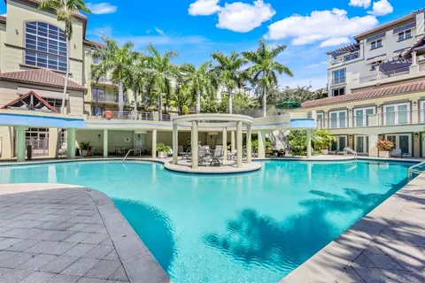 a view of a house with pool yard and sitting area