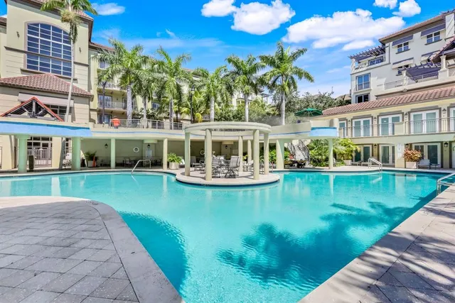 a view of a house with pool yard and sitting area