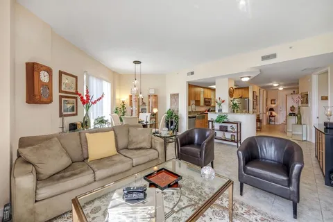 a living room with furniture kitchen view and a table