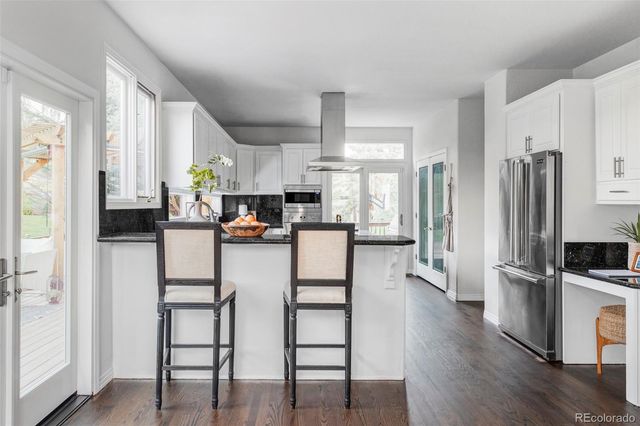 a kitchen with stainless steel appliances a refrigerator sink and cabinets