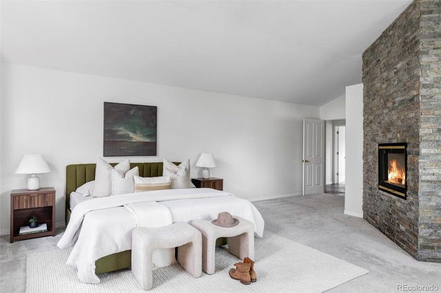 a bedroom with bed and a fireplace