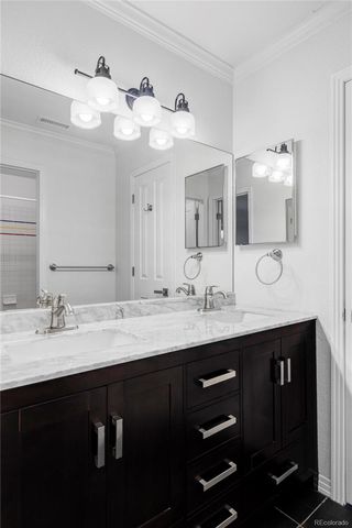 a bathroom with a granite countertop sink a large mirror and vanity
