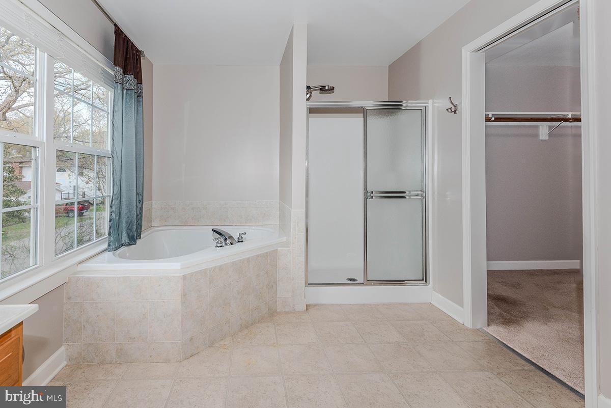 647 210th Street Pasadena, MD 21122 - Photo 18 of 44 a bathroom with a tub shower and a sink