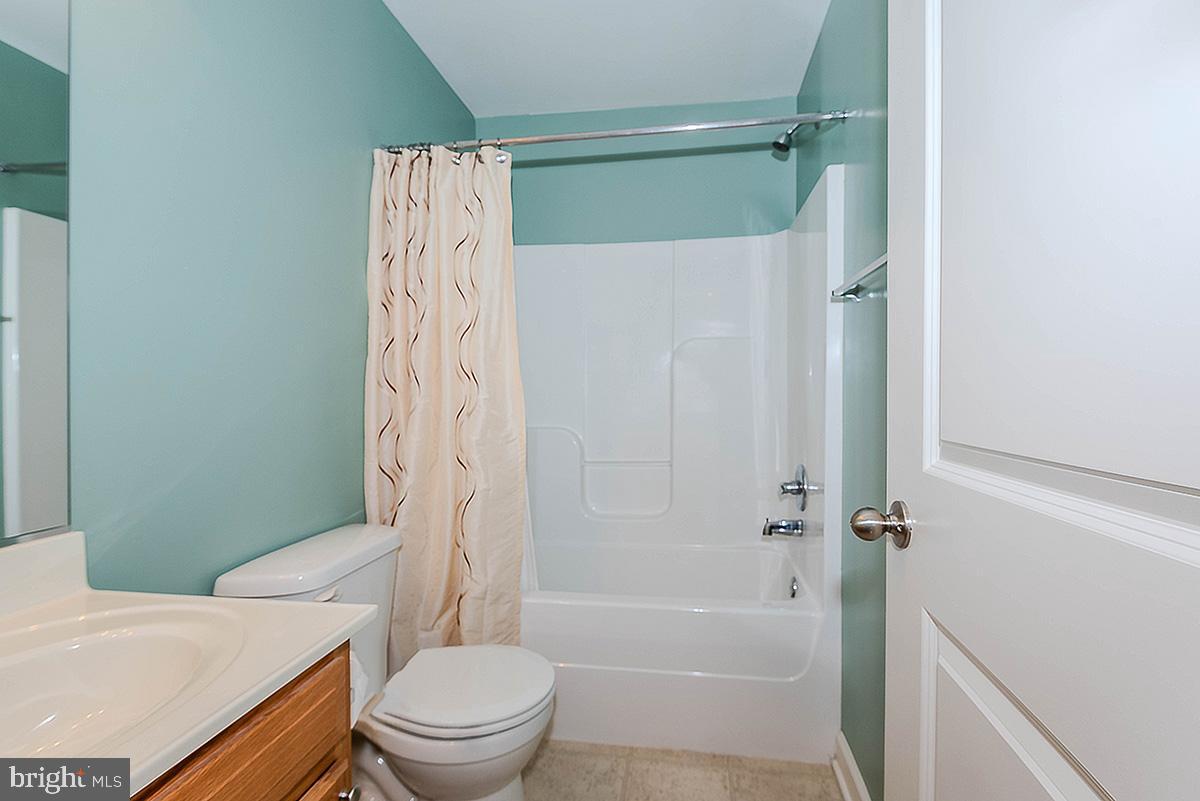 647 210th Street Pasadena, MD 21122 - Photo 23 of 44 a bathroom with a toilet and a shower
