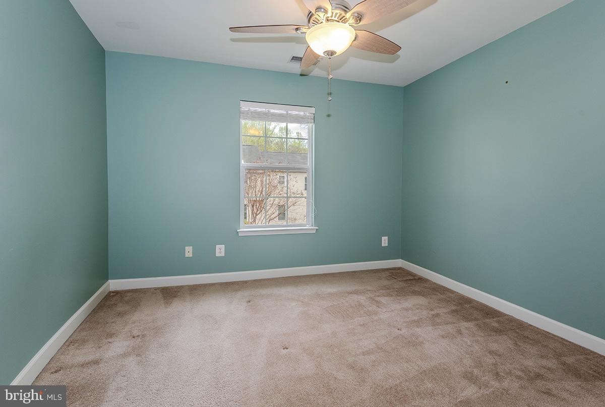 647 210th Street Pasadena, MD 21122 - Photo 24 of 44 an empty room with windows and fan