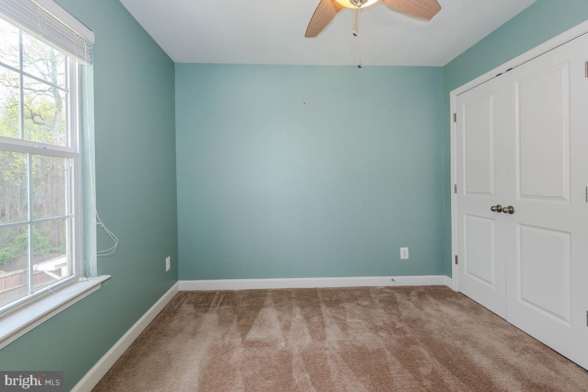 647 210th Street Pasadena, MD 21122 - Photo 25 of 44 an empty room with a window and a fan