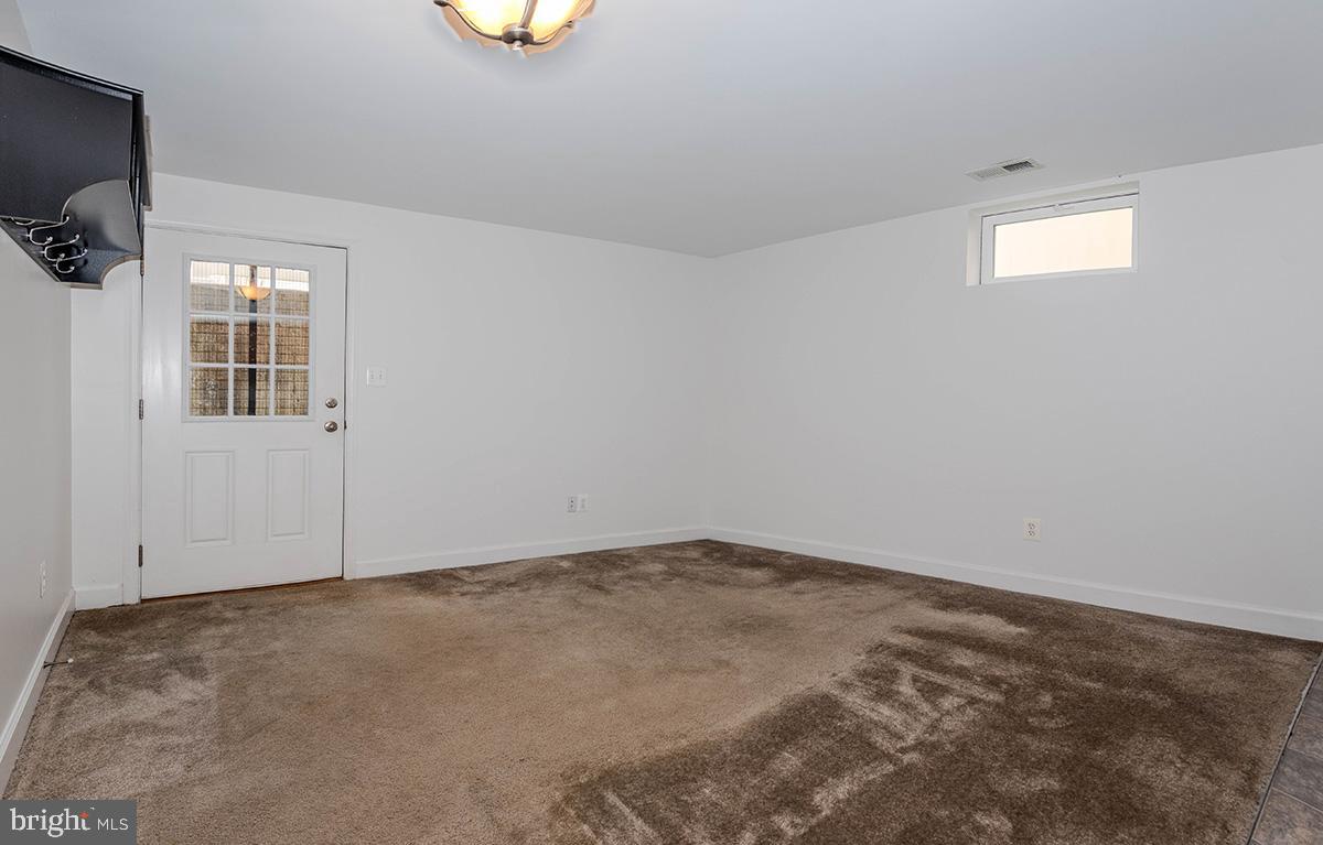 647 210th Street Pasadena, MD 21122 - Photo 27 of 44 an empty room with windows