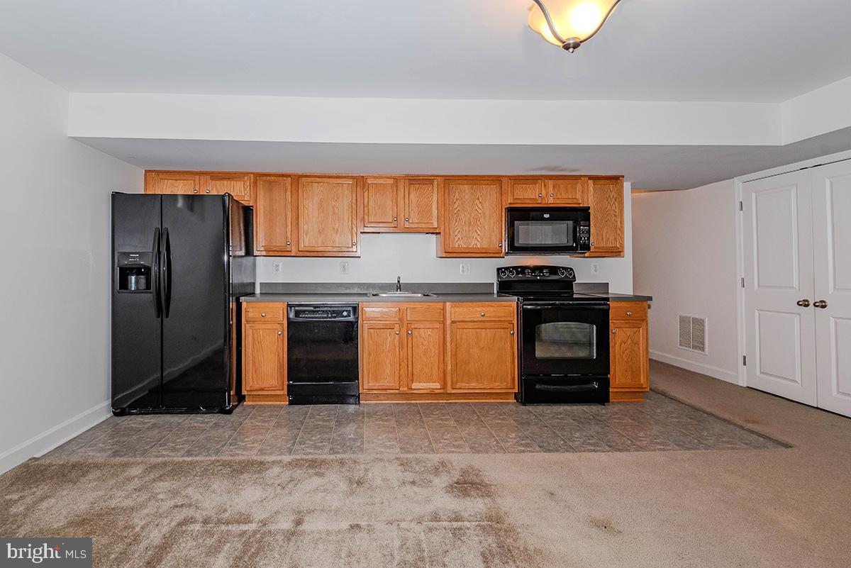 647 210th Street Pasadena, MD 21122 - Photo 29 of 44 a kitchen with stainless steel appliances granite countertop a stove and a refrigerator