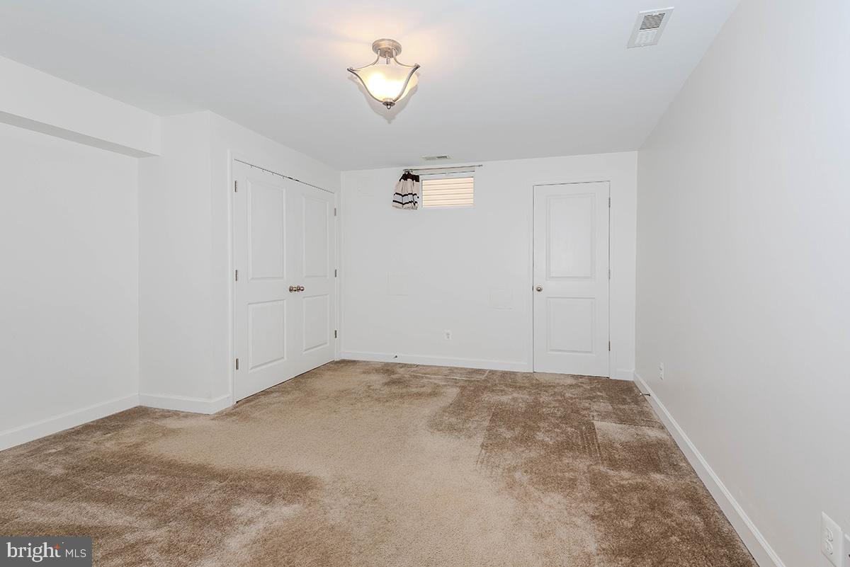 647 210th Street Pasadena, MD 21122 - Photo 32 of 44 an empty room with a chandelier fan