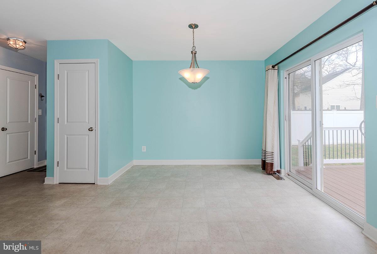 647 210th Street Pasadena, MD 21122 - Photo 10 of 44 an empty room with windows and entrance