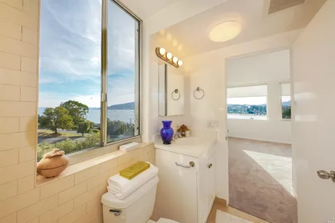 a bathroom with a bathtub sink and mirror