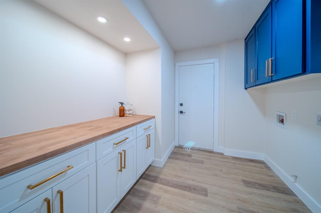 5125 Ashbrook Road Dallas, TX 75227 - Photo 15 of 34 Laundry area with wood-finish flooring, recessed lighting, and a white door with black hardware