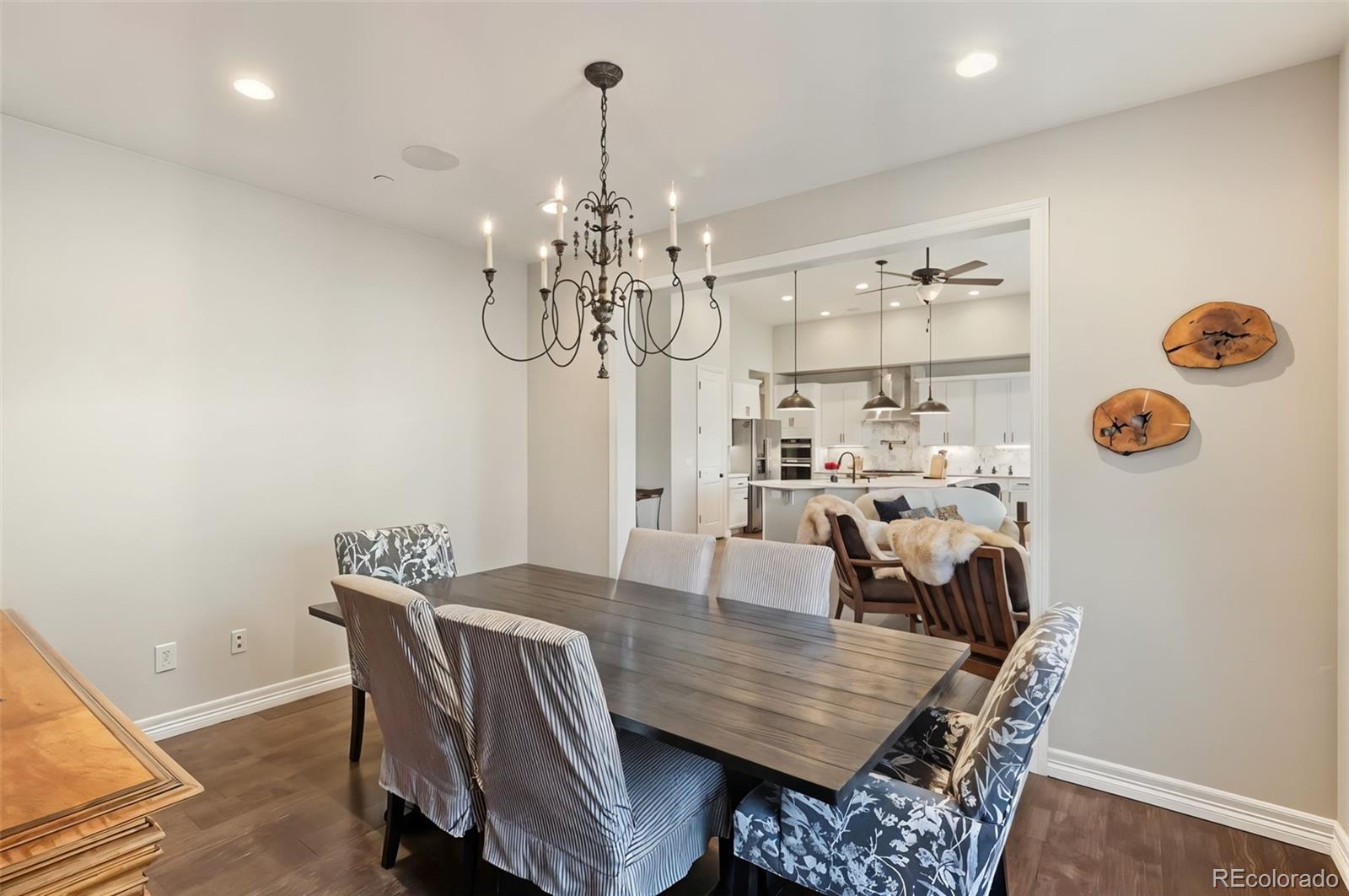 5318 Rocking Tree Grove Colorado Springs, CO 80906 - Photo 11 of 50 a view of a dining room with furniture wooden floor and chandelier
