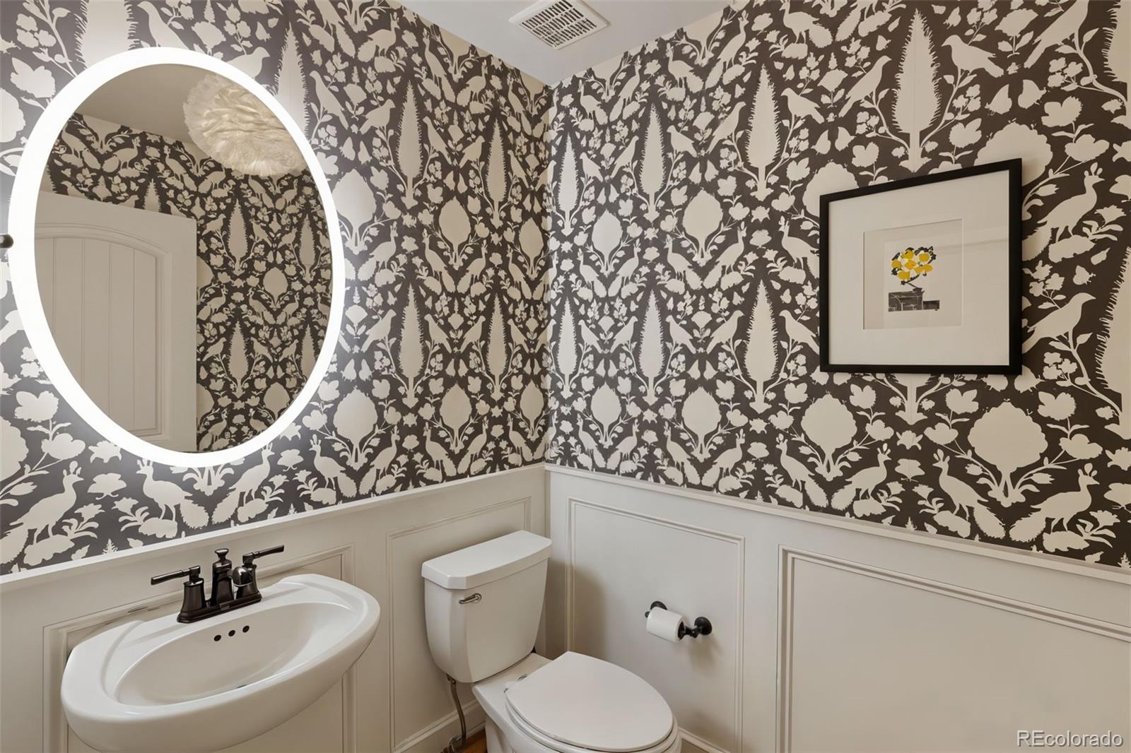 5318 Rocking Tree Grove Colorado Springs, CO 80906 - Photo 14 of 50 a bathroom with a toilet sink and mirror