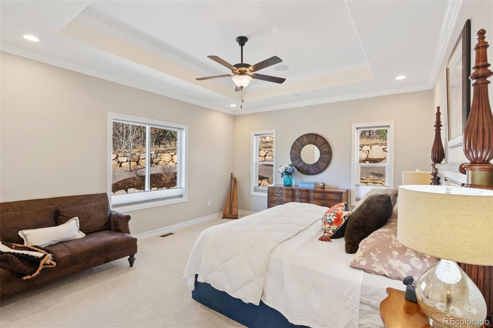 5318 Rocking Tree Grove Colorado Springs, CO 80906 - Photo 16 of 50 a bedroom with a bed couch and window