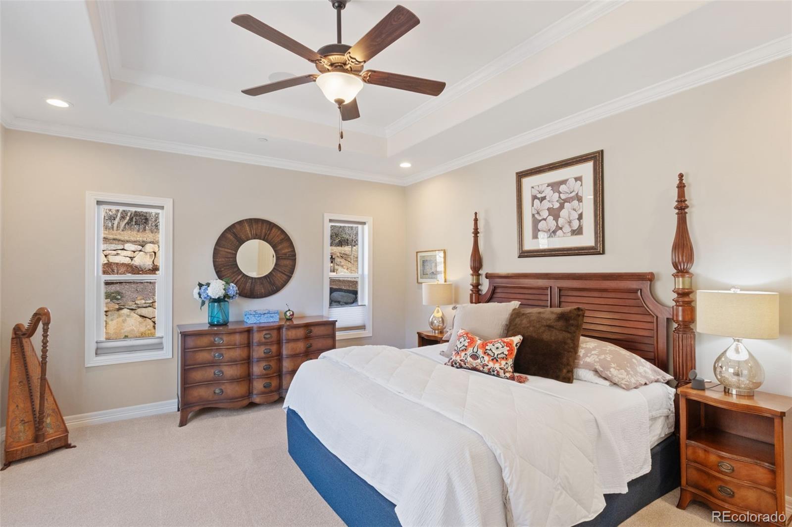 5318 Rocking Tree Grove Colorado Springs, CO 80906 - Photo 17 of 50 a bedroom with a bed and a chandelier