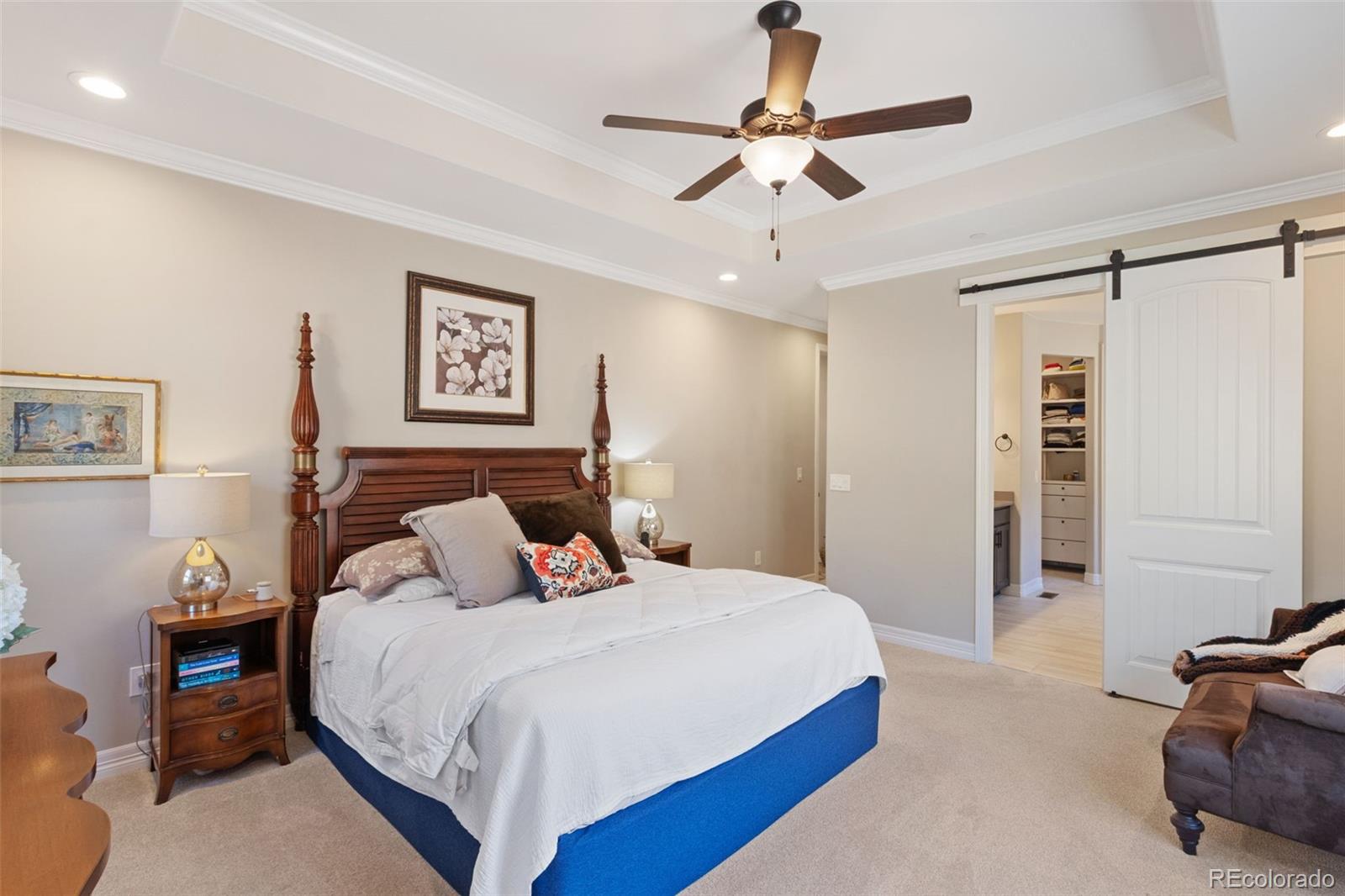 5318 Rocking Tree Grove Colorado Springs, CO 80906 - Photo 18 of 50 a bedroom with a bed and a chandelier