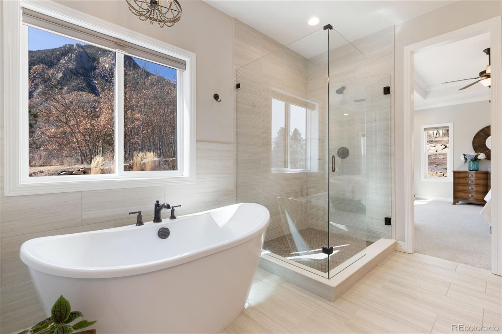 5318 Rocking Tree Grove Colorado Springs, CO 80906 - Photo 21 of 50 a white bath tub sitting next to a shower