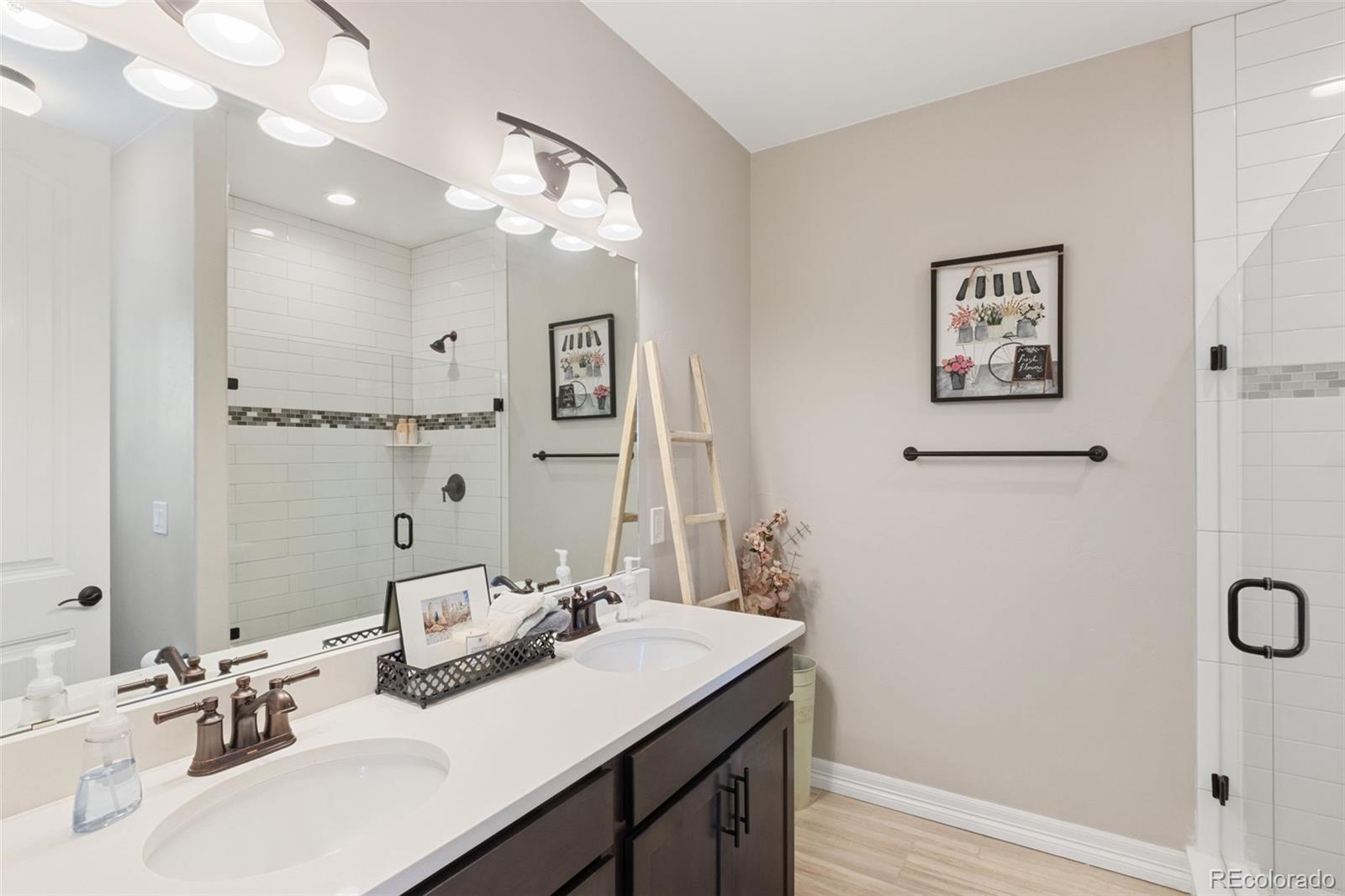 5318 Rocking Tree Grove Colorado Springs, CO 80906 - Photo 24 of 50 a bathroom with a sink vanity and a mirror