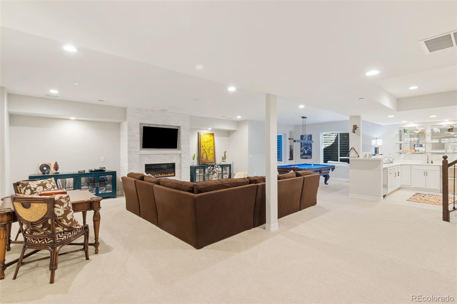5318 Rocking Tree Grove Colorado Springs, CO 80906 - Photo 26 of 50 a living room with furniture and a flat screen tv