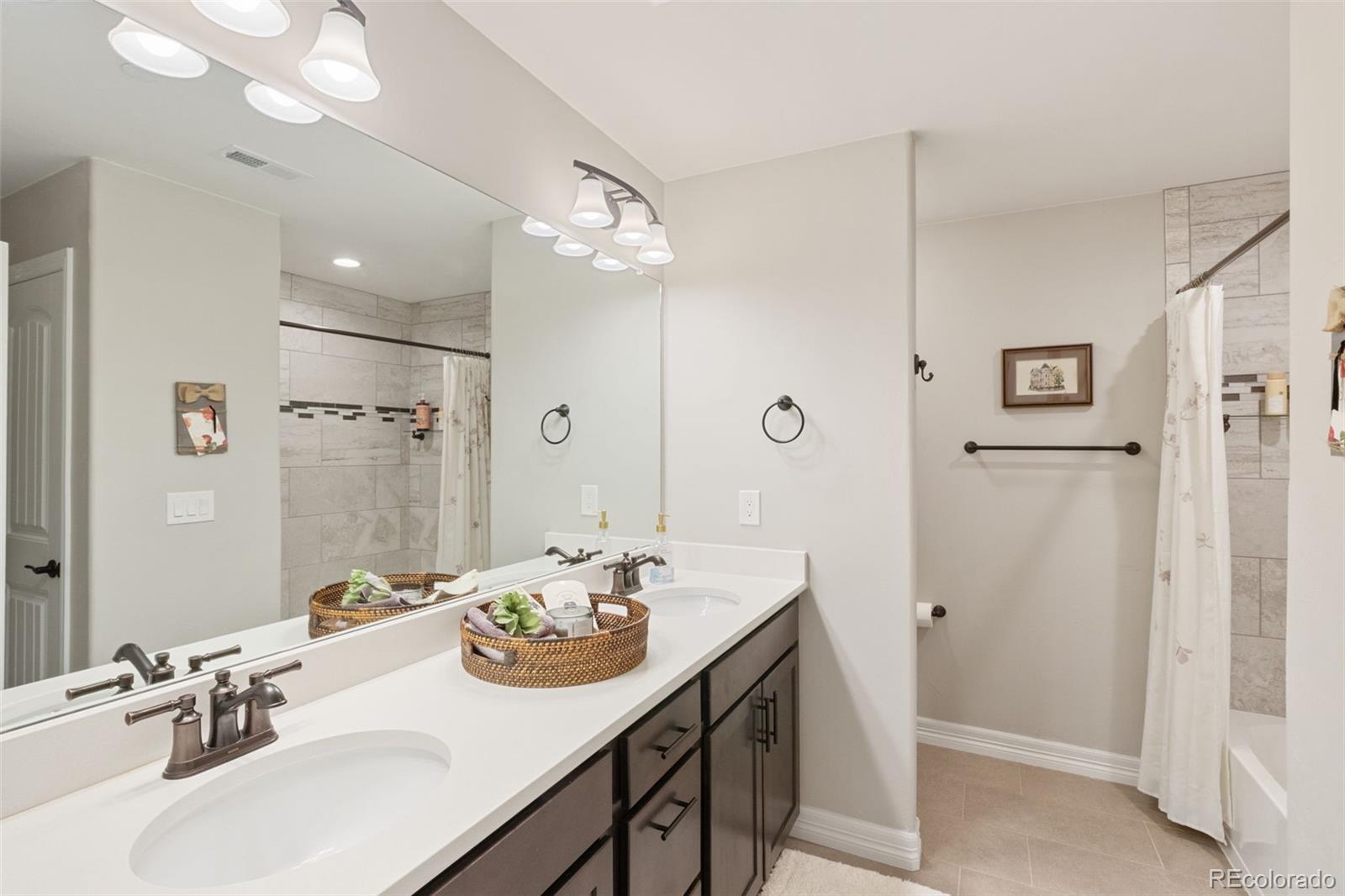 5318 Rocking Tree Grove Colorado Springs, CO 80906 - Photo 34 of 50 a bathroom with a sink double vanity and a mirror