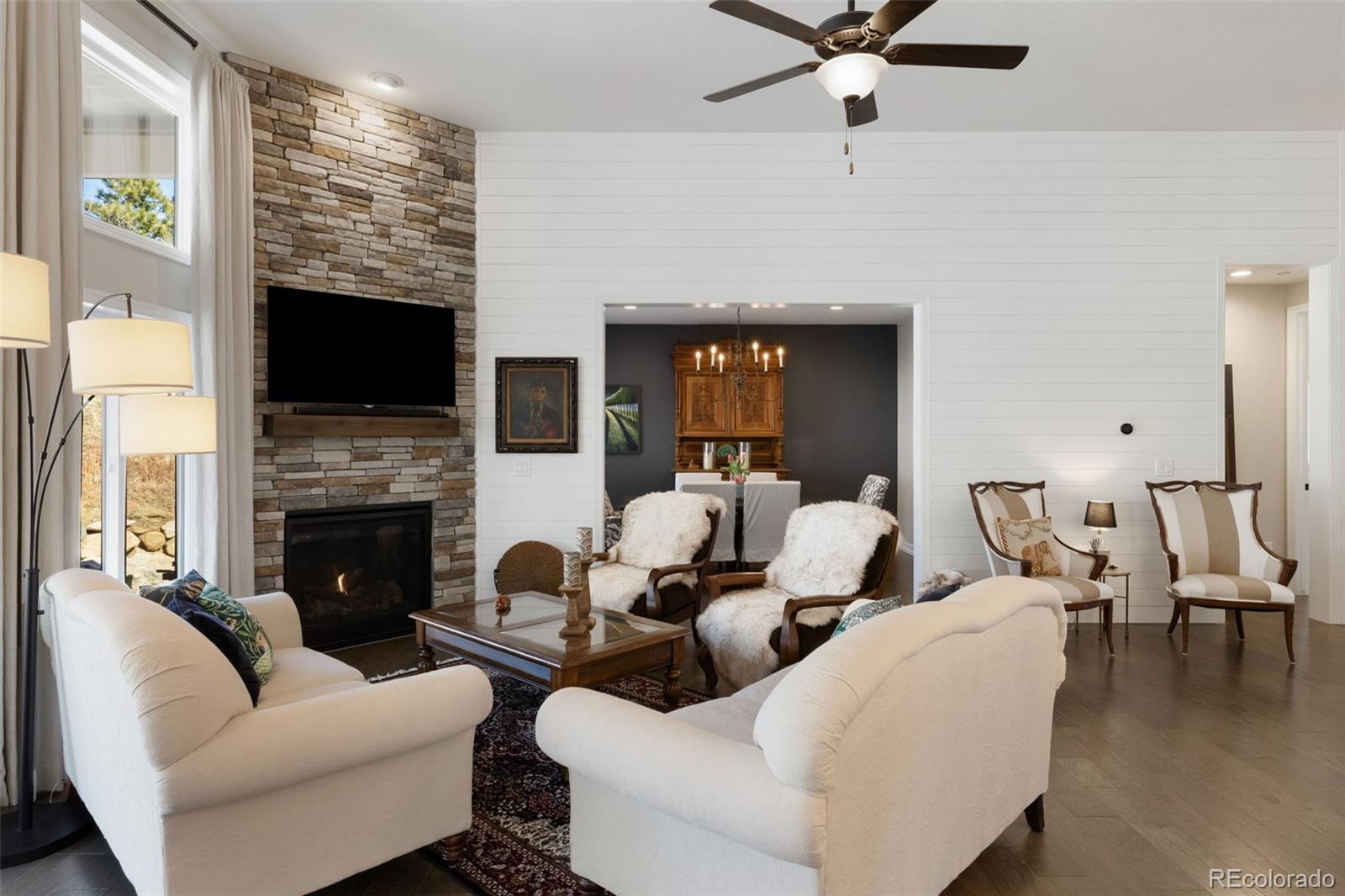 5318 Rocking Tree Grove Colorado Springs, CO 80906 - Photo 5 of 50 a living room with fireplace furniture and a flat screen tv