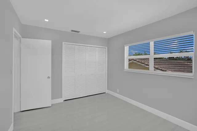 a view of a room with wooden floor and window