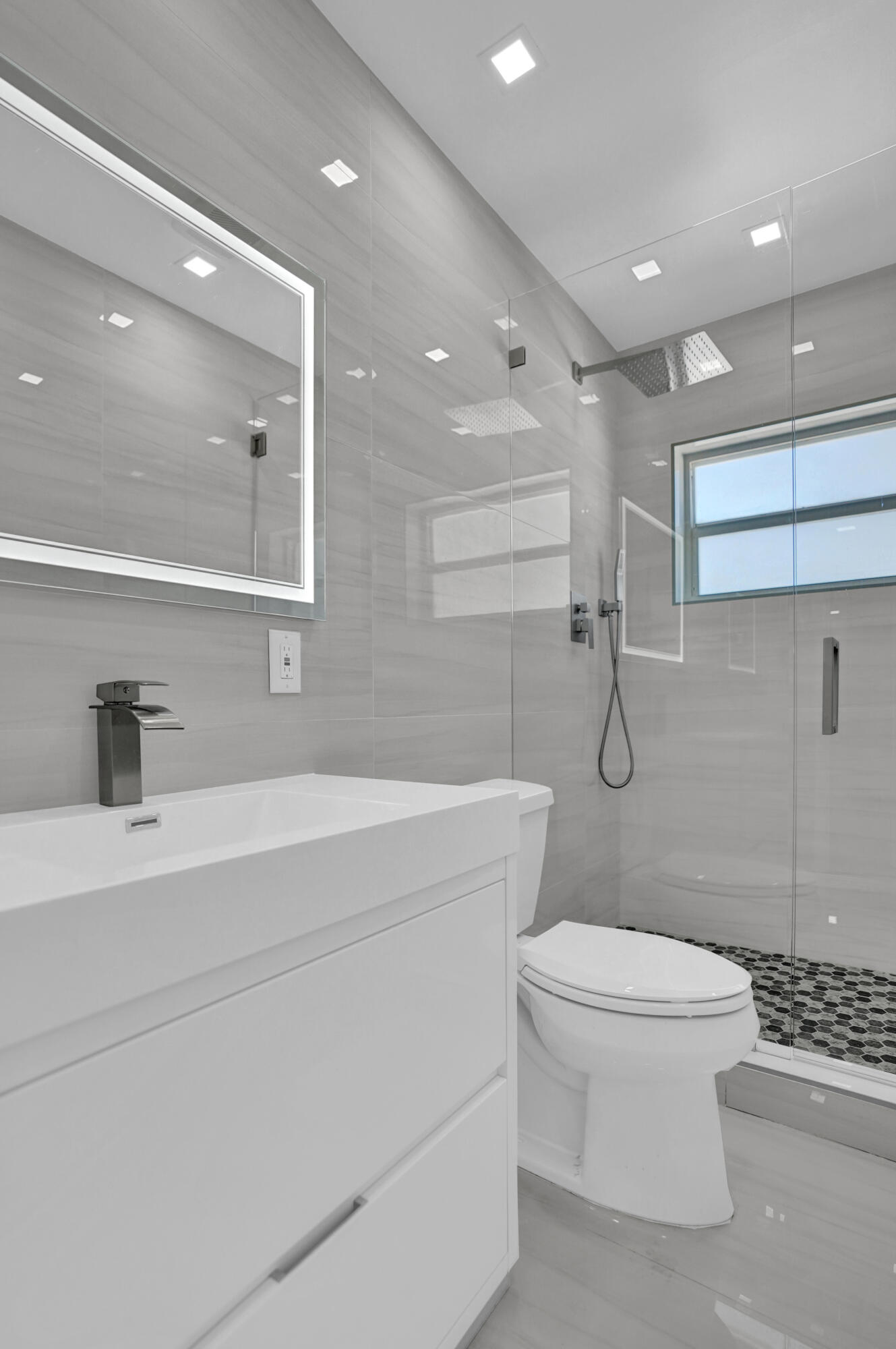 2755 Northeast 28th Avenue, Unit F2 Lighthouse Point, FL 33064 - Photo 23 of 32 a bathroom with a toilet a sink and a mirror