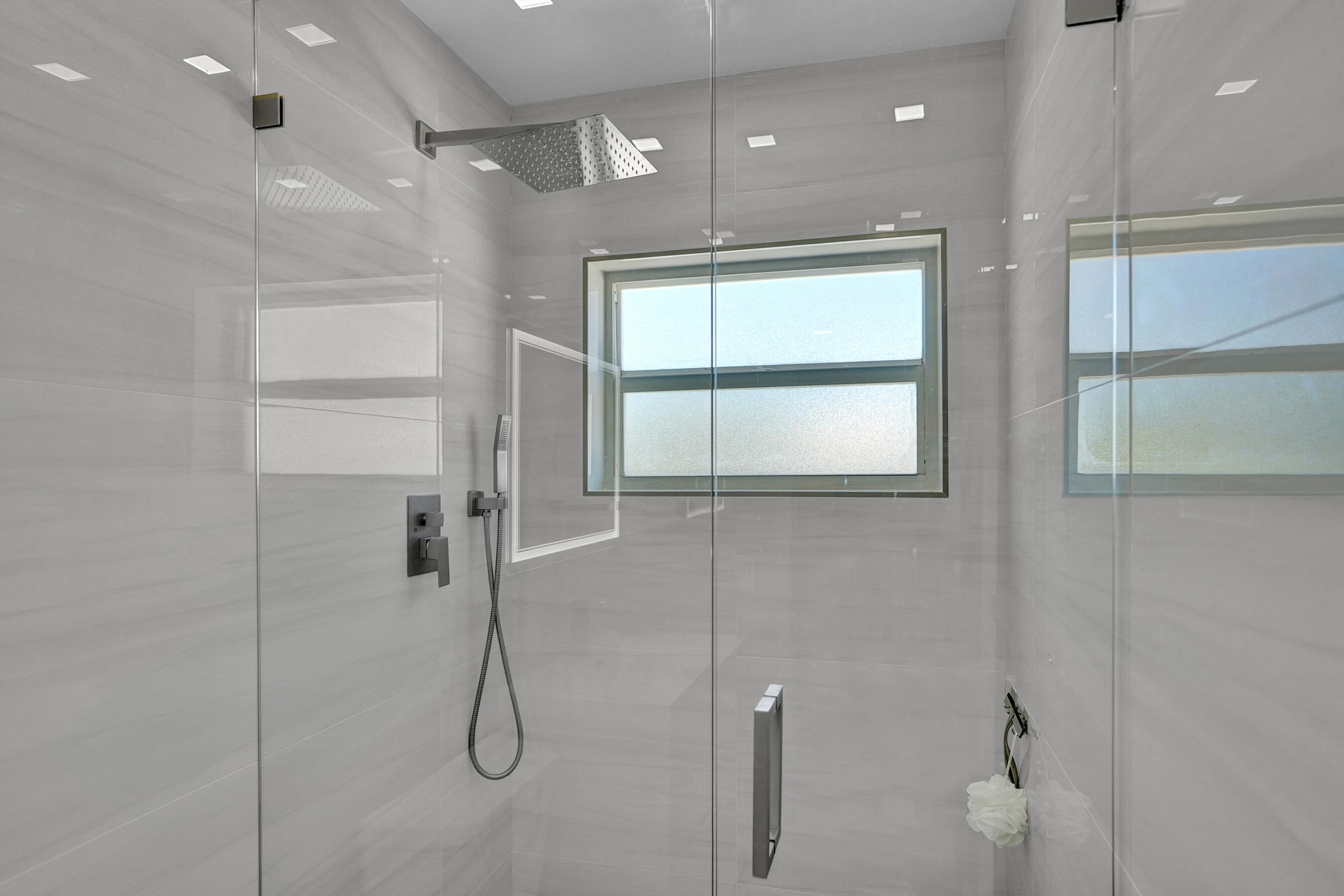 2755 Northeast 28th Avenue, Unit F2 Lighthouse Point, FL 33064 - Photo 24 of 32 a bathroom with a shower