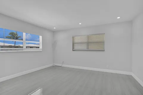 a view of a room with wooden floor and window