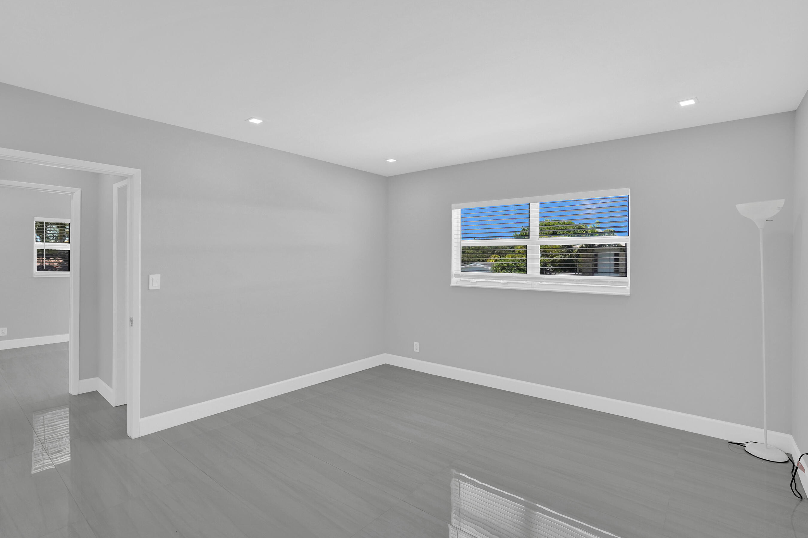 2755 Northeast 28th Avenue, Unit F2 Lighthouse Point, FL 33064 - Photo 30 of 32 a view of a room with wooden floor and window