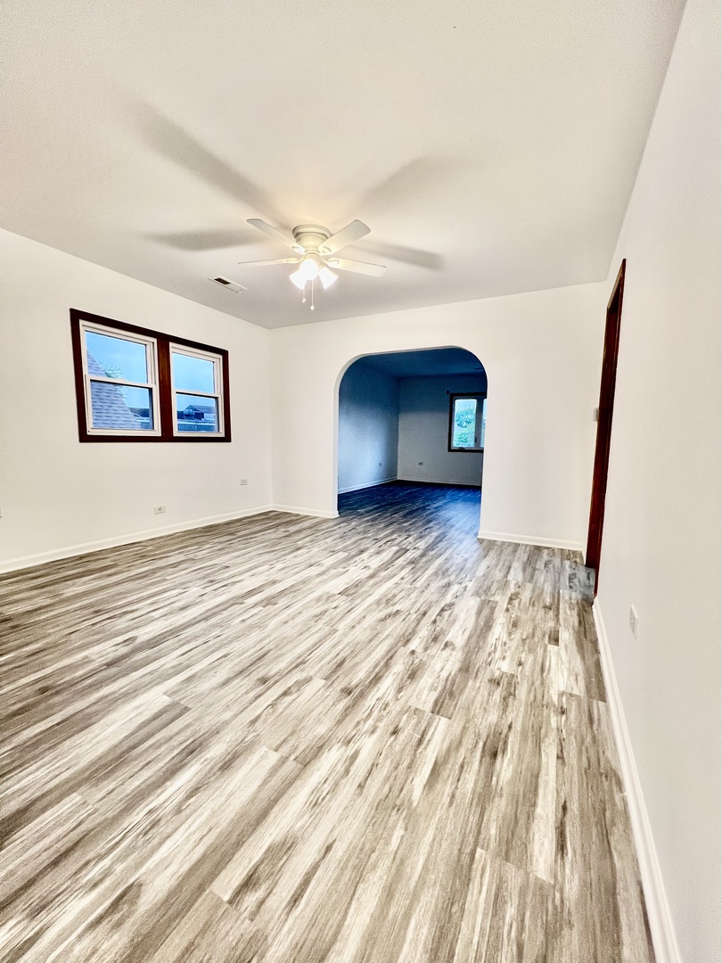 137 North 12th Avenue, Unit 2 Melrose Park, IL 60160 - Photo 2 of 8 a view of empty room with wooden floor