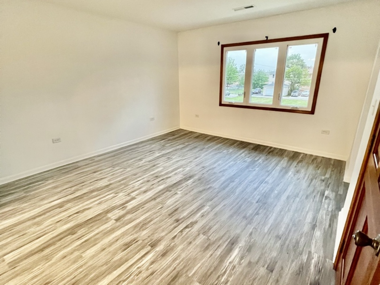 137 North 12th Avenue, Unit 2 Melrose Park, IL 60160 - Photo 3 of 8 an empty room with wooden floor and windows