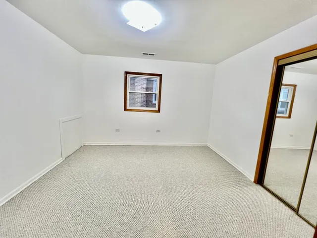 an empty room with a mirror