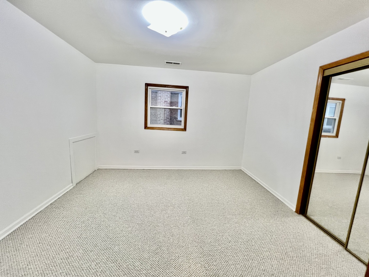 137 North 12th Avenue, Unit 2 Melrose Park, IL 60160 - Photo 4 of 8 an empty room with a mirror