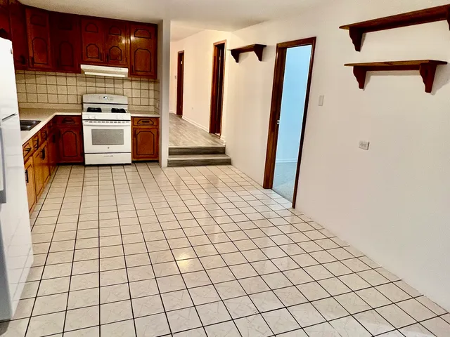a kitchen with a sink and a refrigerator