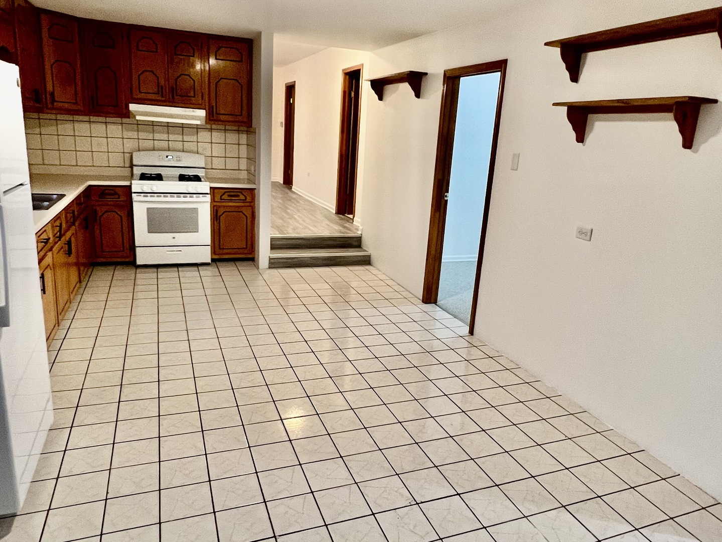 137 North 12th Avenue, Unit 2 Melrose Park, IL 60160 - Photo 7 of 8 a kitchen with a sink and a refrigerator