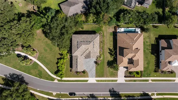 a dining room with furniture a chandelier and wooden floor